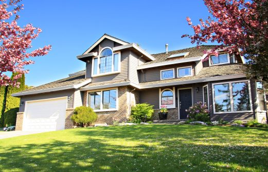 Beautiful house and front yard with cherry blossoms.