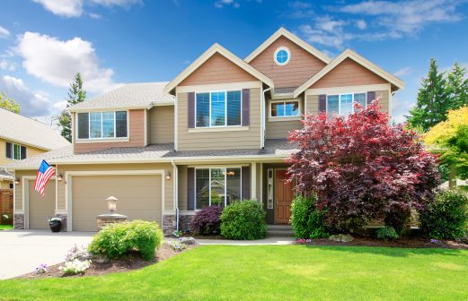 American beige luxury large house front exterior with landscape.
